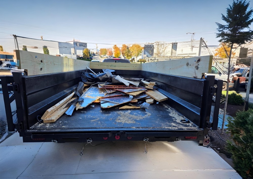 Bailey’s Haulworks dump trailer parked on a work site ready for rental, hauling and demo services